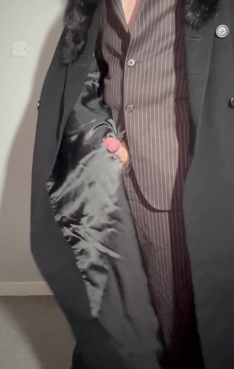 Sissy playing with cock in a ladies long coat and suit stroking myself with the lining of my coat
