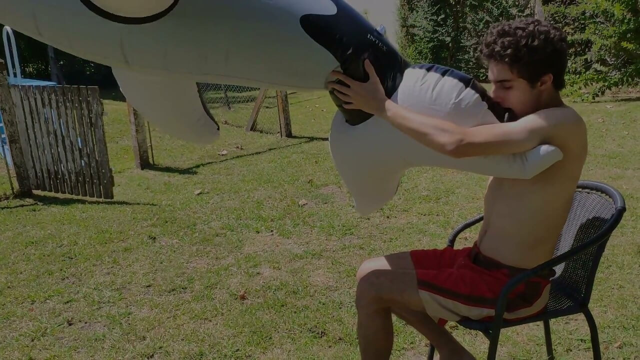 Beautiful Man Inflates His Inflatable Whale Near Pool Outside