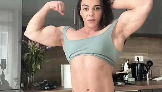 Naked female bodybuilder showing off her competition poses