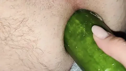 My wife is fucking my ass with a huge cucumber.