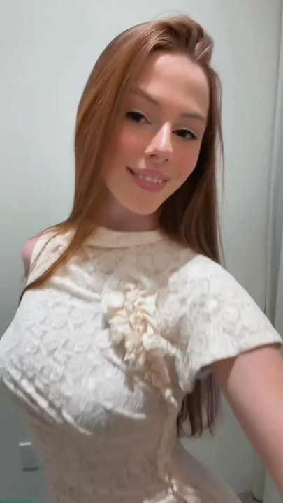 Showing off this delicate white lace dress in the fitting room