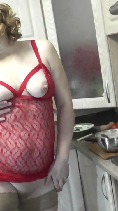 Emotional moment from "Sexy MILF continues cooking in kitchen naked without panties and bra in red transparent negligee."