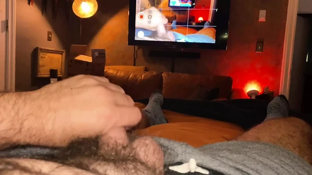 VERBAL Hairy Dad bates in Bed while watching himself on TV
