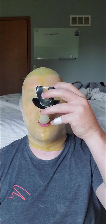 Latex Hooded Slut Swallows Load from Condom