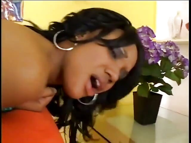 Horny black whore enjoys getting her pussy fucked on the orange couch