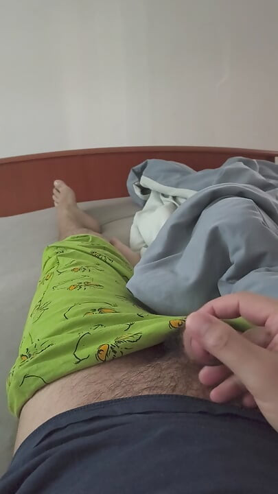 Cute handjob on the bed with a hard and erect penis