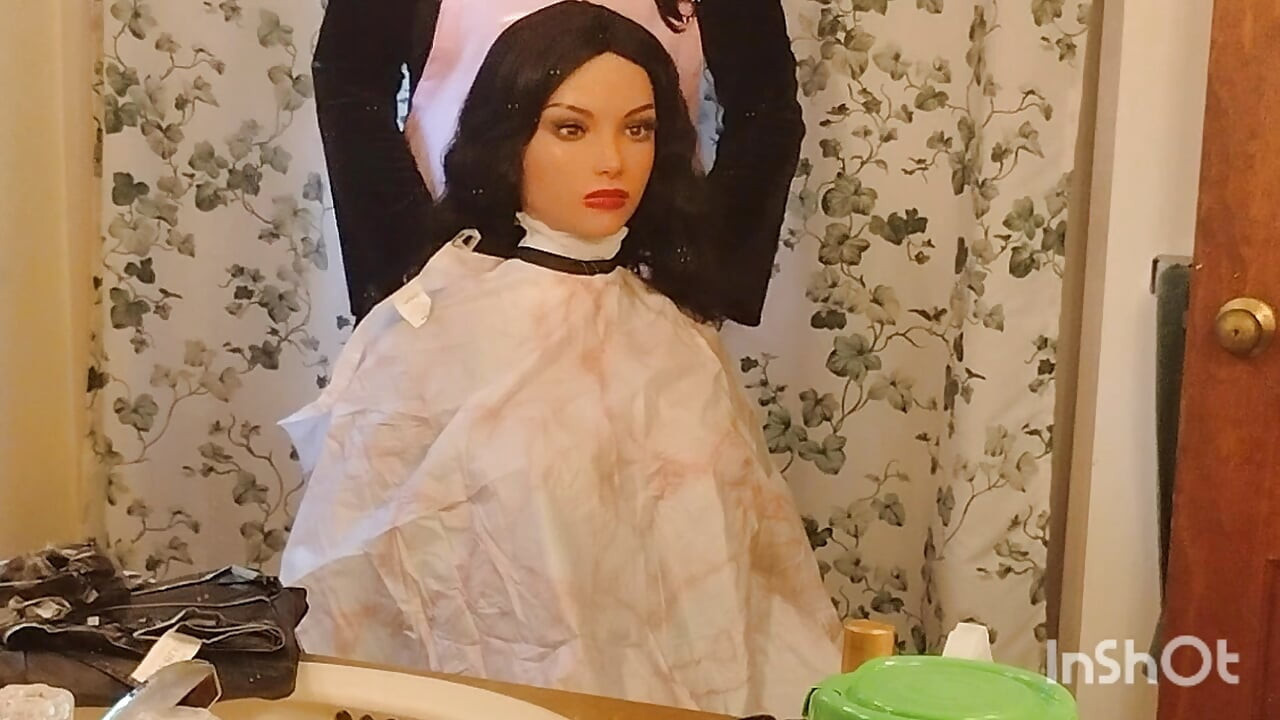 Emma the barberette shows off sexy vinyl shampoo capes