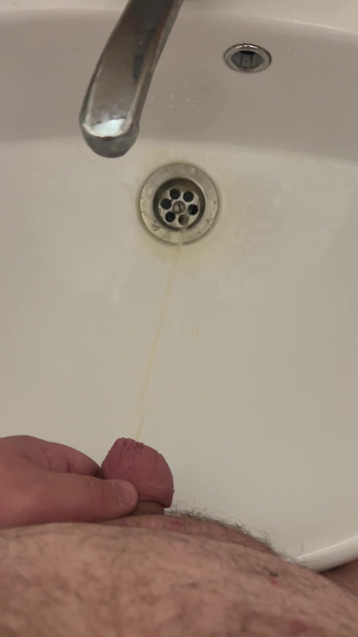 Fat man with a small dick pees in the sink