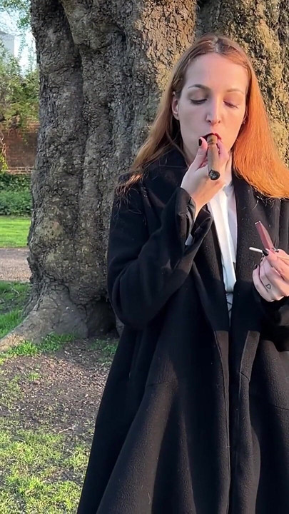 Liz Rainbow Smoking a Flor De Oliva Cigar Outdoors