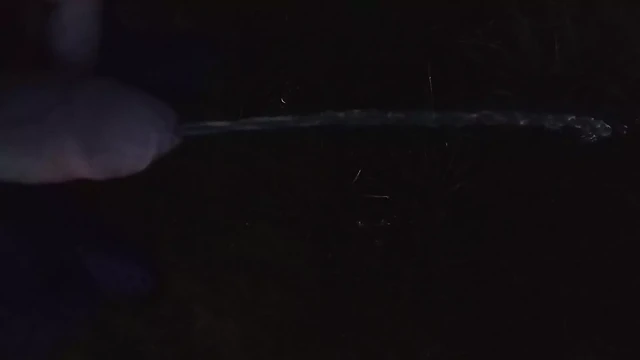 Boy pissing on highway parking lot