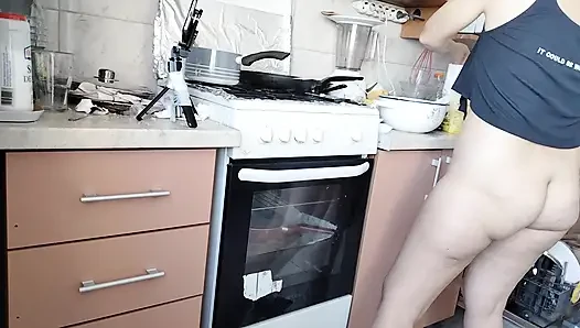 Sexy wife prepares lunch naked in the kitchen.