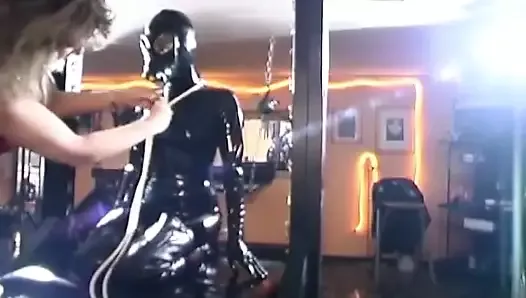 Latex slave tied up in bondage