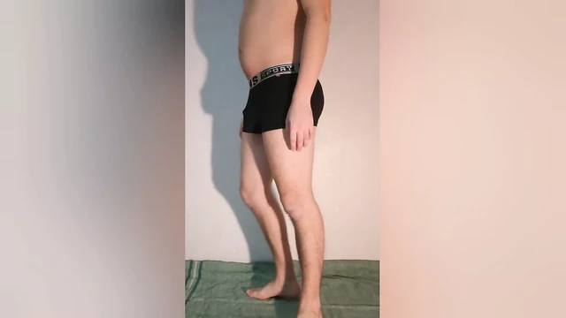 The guy shows how the chastity belt looks in boxer briefs