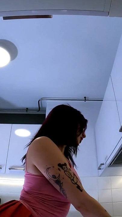 Stunning moment from "Hottest redhead tattooed cheerleader with over knee socks shows her see through panties in the kitchen"