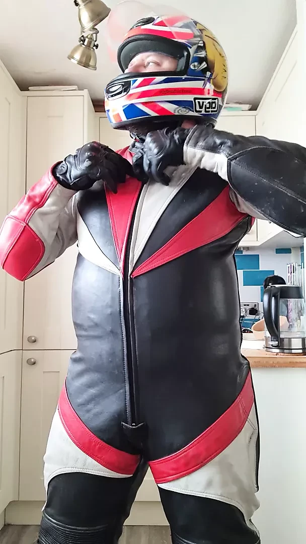 Wanking in biker leathers and helmet