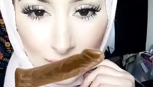 Hijabi rubs cock on face