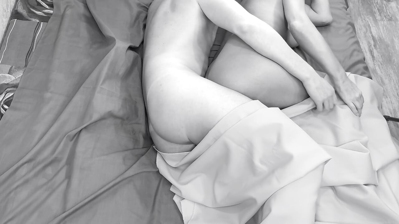 Couple caught on camera having sex in bed .