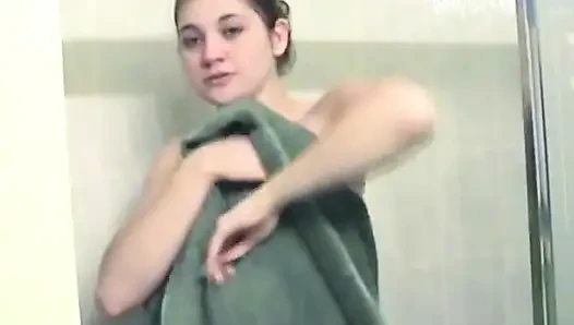 Brunette taking shower and rubs sexy nipples and pussy