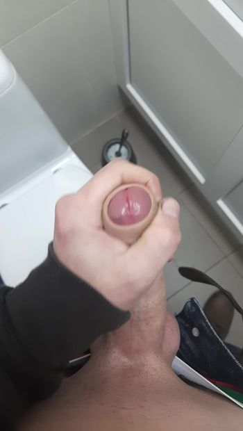 Jerking off a cock in the toilet at work