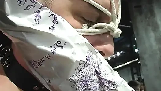 BDSM mistress in thigh-highs ropes dude's collared face and pulls his bound cock