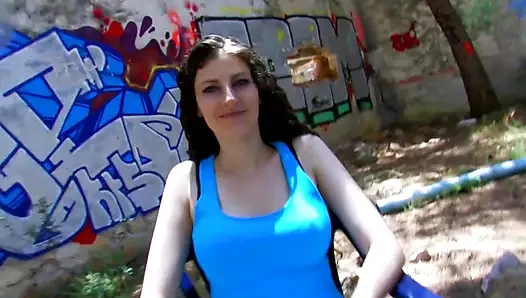 Hot brunette gives a blowjob in a park