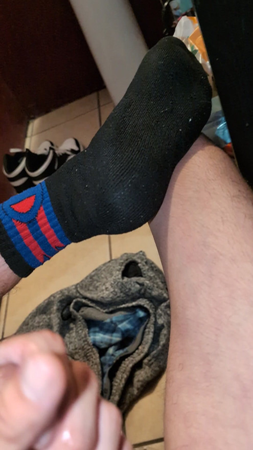 Jacking off naked in my black and red socks