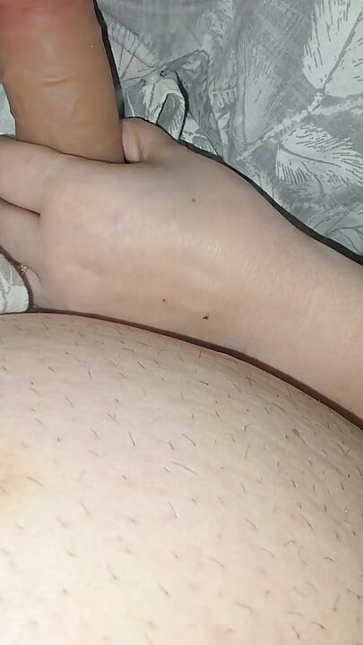 Step sister surprises step brother with a handjob while they watch a movie