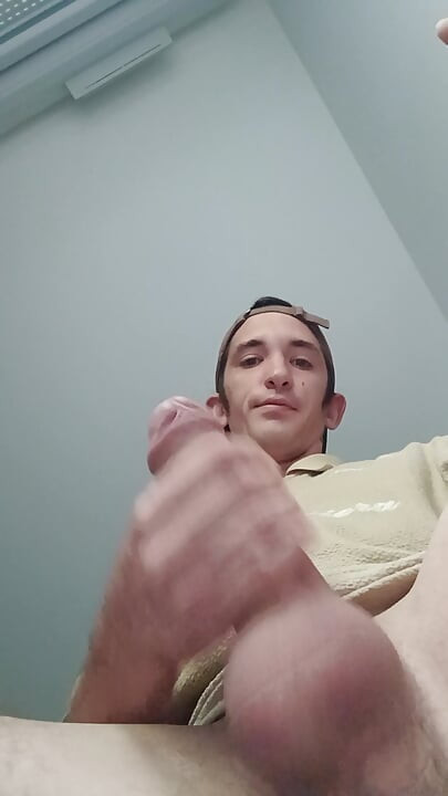 Young guy jerks off his big cock and cums