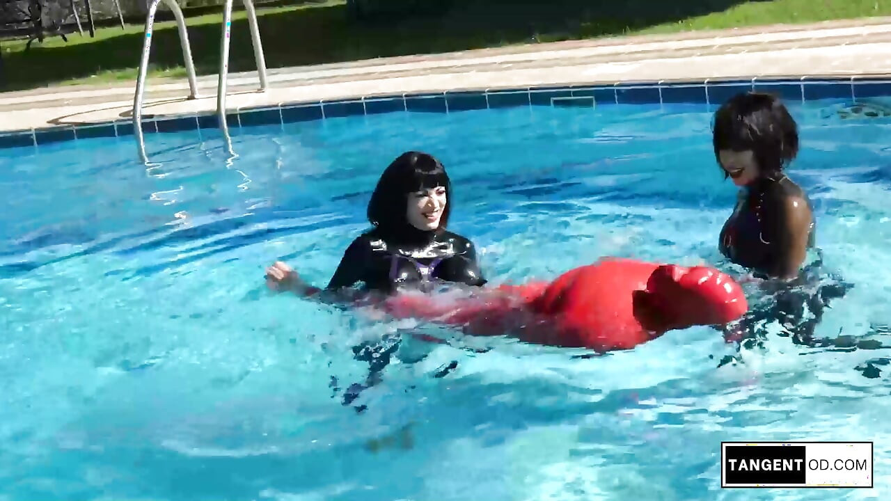 TANGENTOD Women in Black Catsuits Float Red Latex Encased Figure on Inflatable Rubber Pool Toy