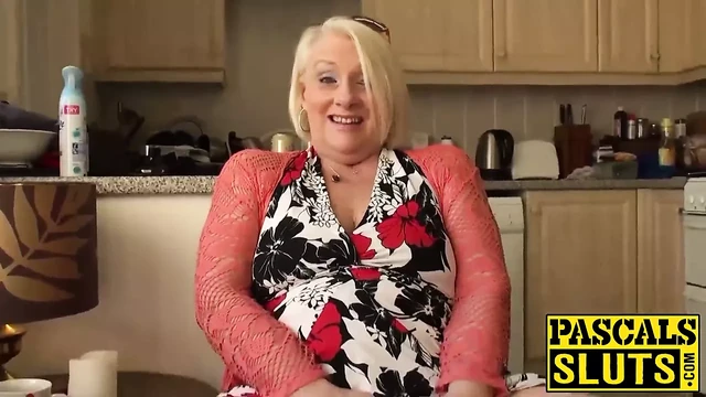 British mature blonde granny Carol fingers her wet pussy