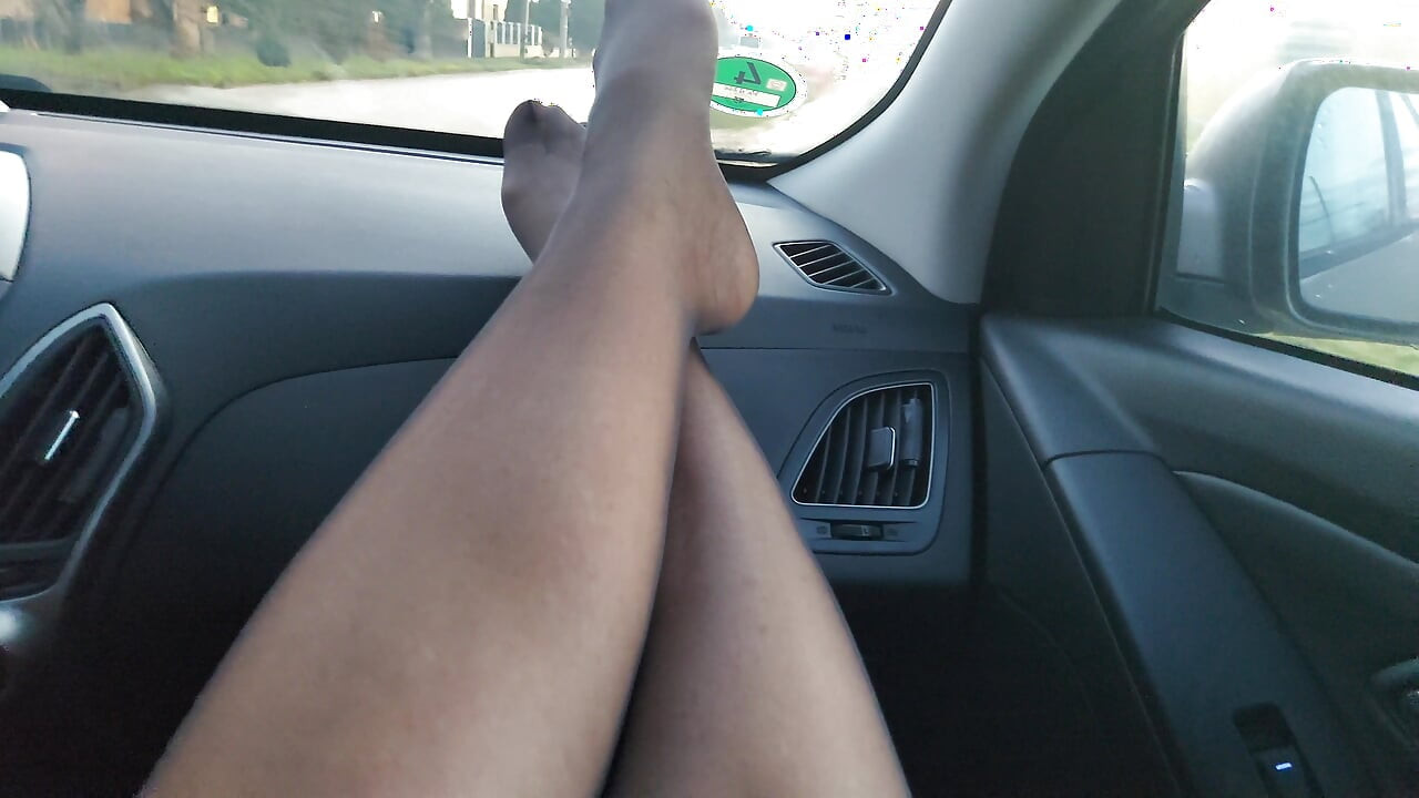 Gorąca dojrzała macocha w pończochach daje pasierbowi footjob w samochodzie, podczas gdy on jeździ