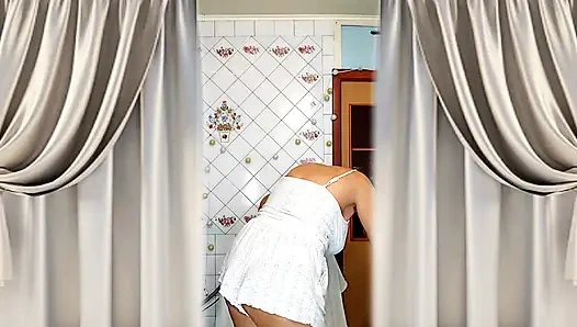 Real home solo of a mature woman in a small cozy kitchen.