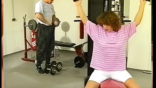 Lovely milf is riding a ripped guy's cock in the gym
