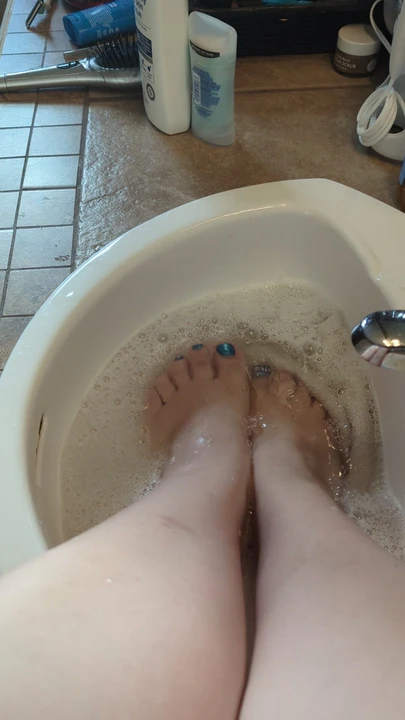 Feet getting soapy and wet.