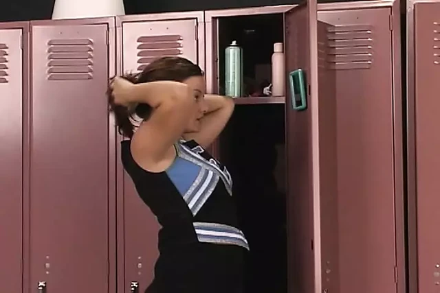 A busty teen girl pleasing herself with her sex toys after a practice