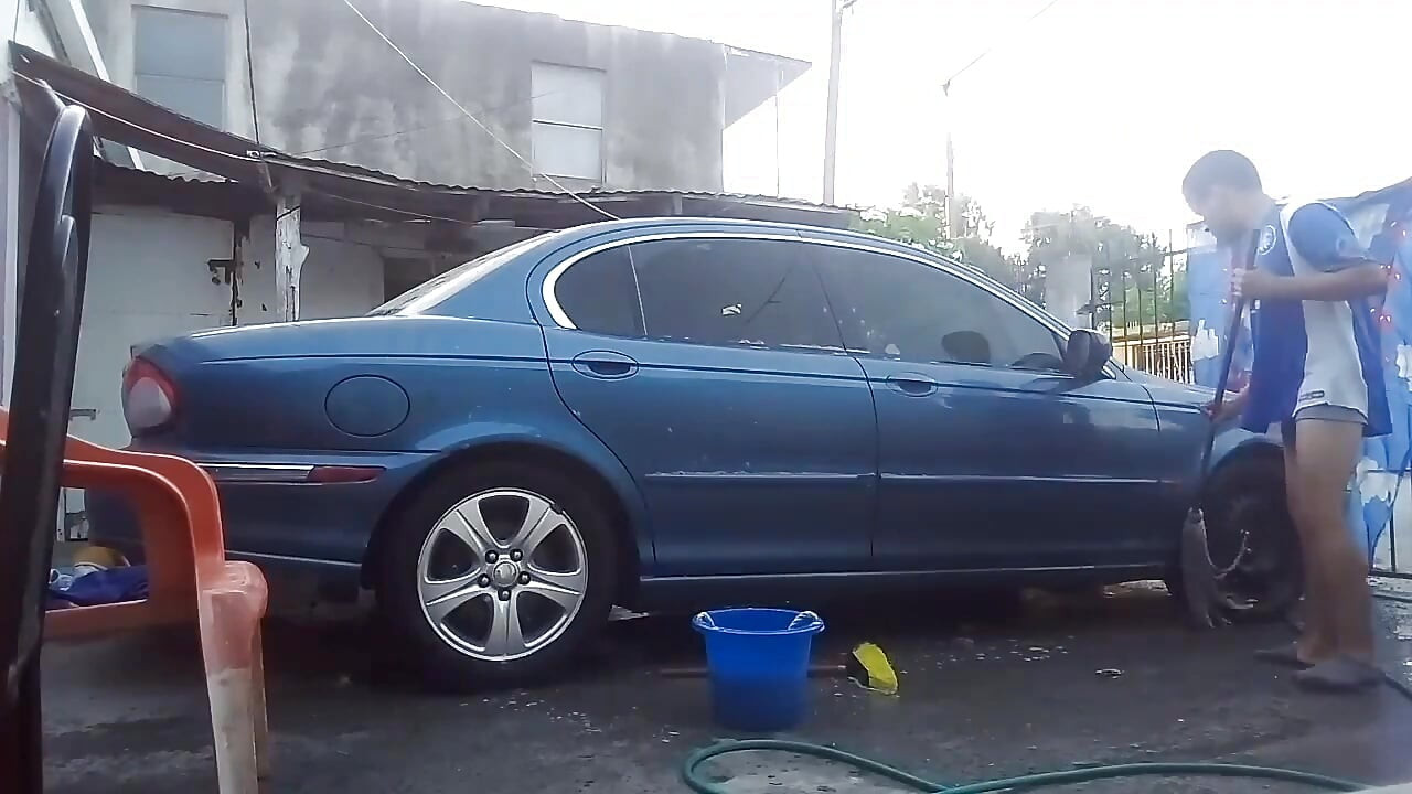 Jesus in gray boxer washing his jaguar car