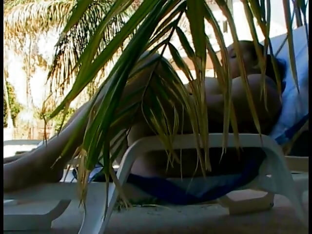 Playful thick newspaper brunette Elizabeth Rollings paddles her pickle sitting in the sun lounger