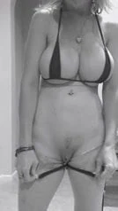 MILF with huge tits shows her kitty in strip tease