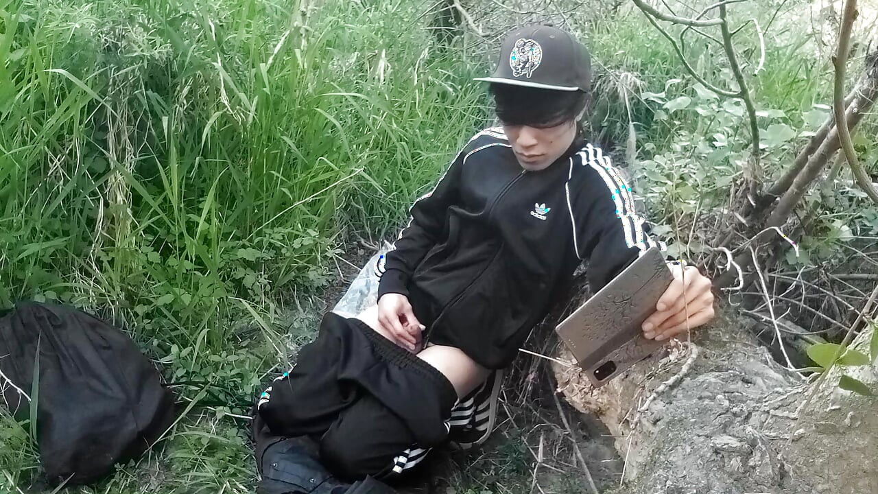 Cute Asian gay twink in a black-and-white adidas tracksuit and Campus sneakers masturbates and cums outdoors