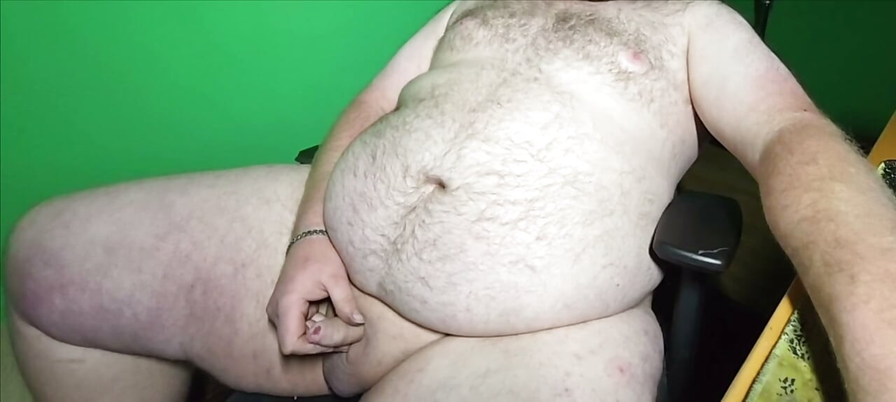 A fat boy with a small dick is masturbating.