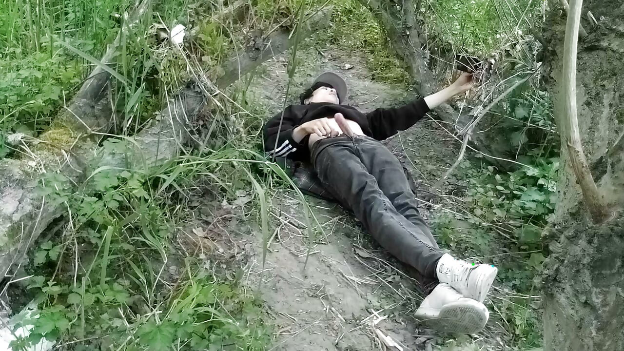 Cute Jon Arteen Gay twink jerks off outdoors, dry-humps the air, and shoots cum through a hole in his pants