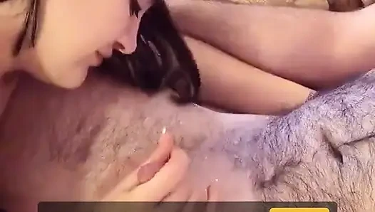 Brunette undresses and kneels to suck white dude's little dick