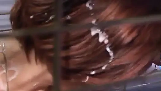 Submissive slut blowing police officers dick while in cage