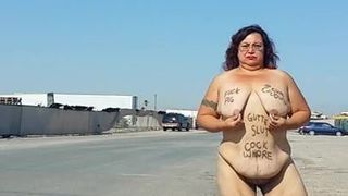 Slut outdoors with body writing