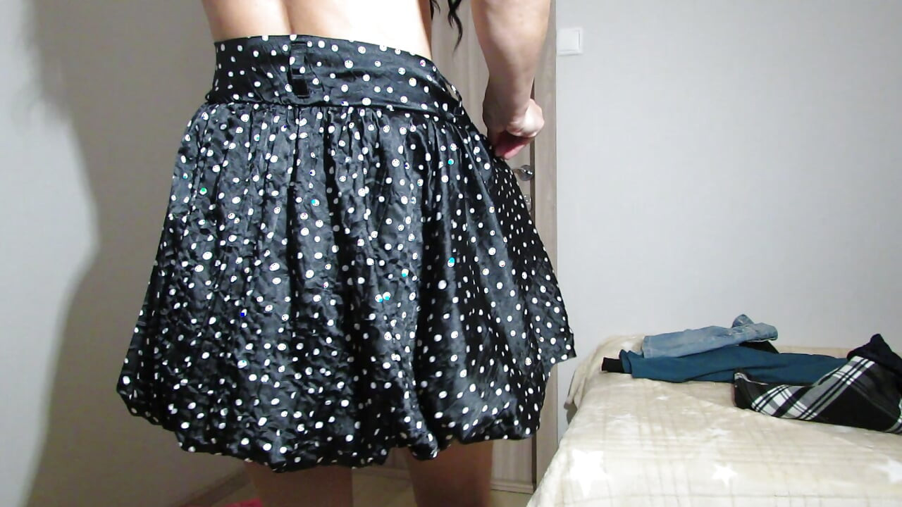 Trying on skirts by a lady without panties and in a bra with open nipples