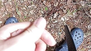 Boy pissing in the forest