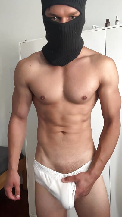 Young bodybuilder teasing in balaclava