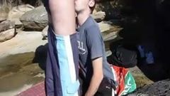 young guy chokes on a load of cum at the beach