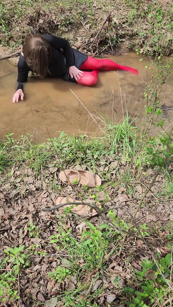 Must-see moment from "Crossdressed outdoors playing in a stream. Wearing pantyhose and miniskirt."