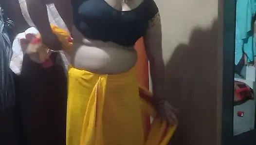 Indian housewife is wearing a yellow saree.